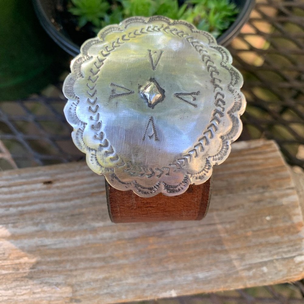 Very old Navajo concho set on old  leather.  8"